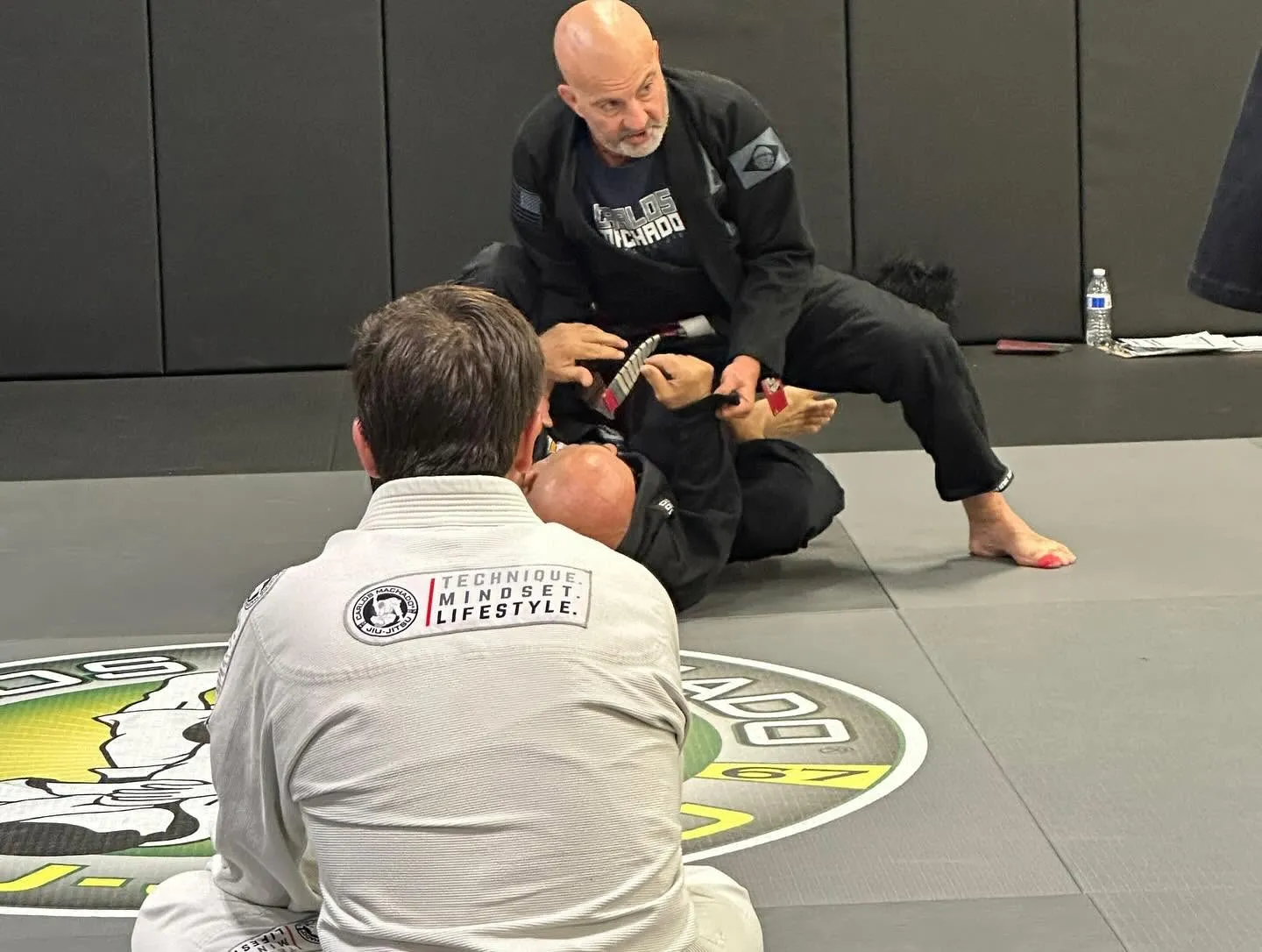 A Machado Method coach teaching a jiu-jitsu detail during an adult class in Carrollton, TX