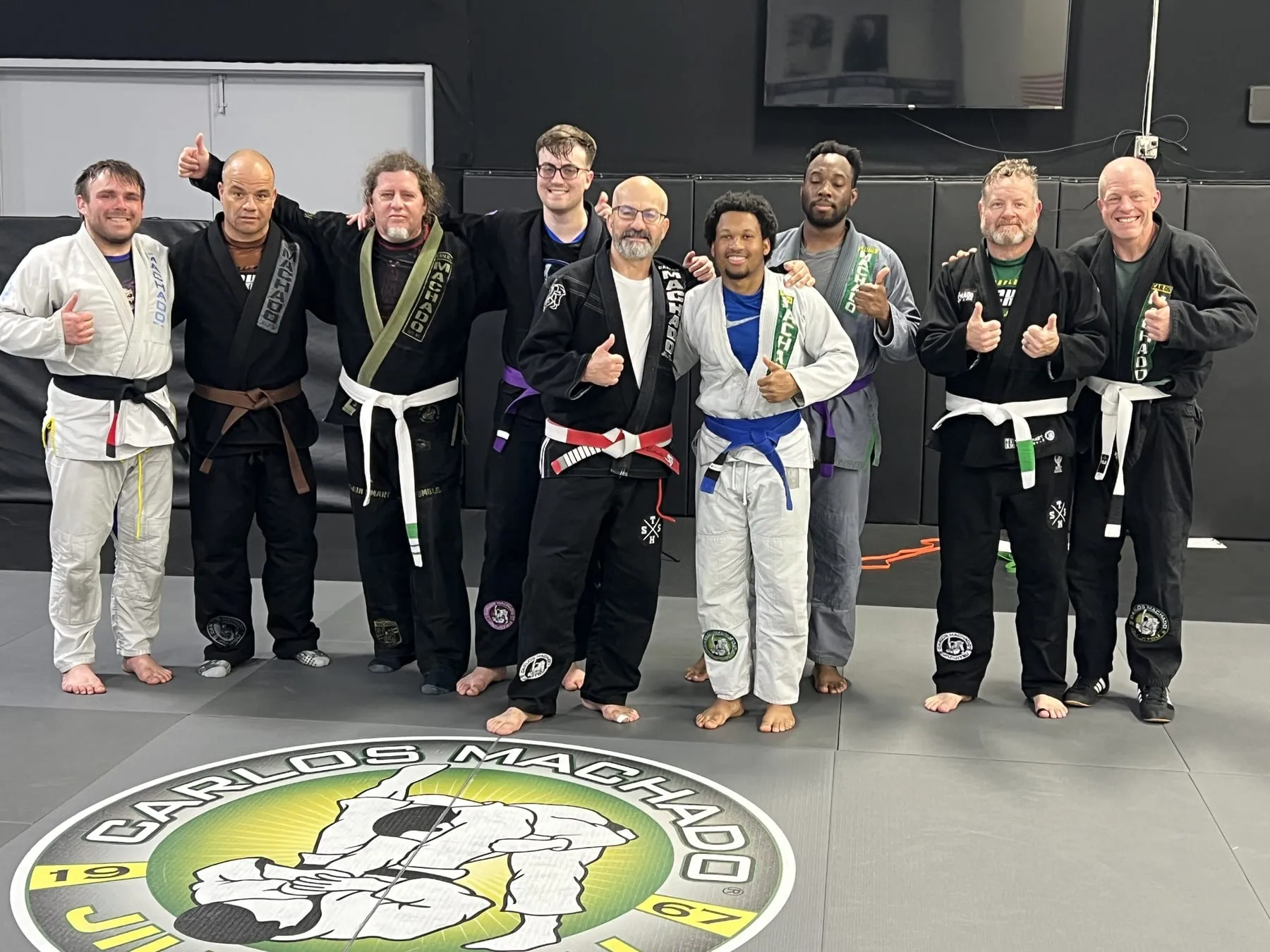 A group of adult Machado Method students together after a Brazilian Jiu-Jitsu class in Carrollton, TX