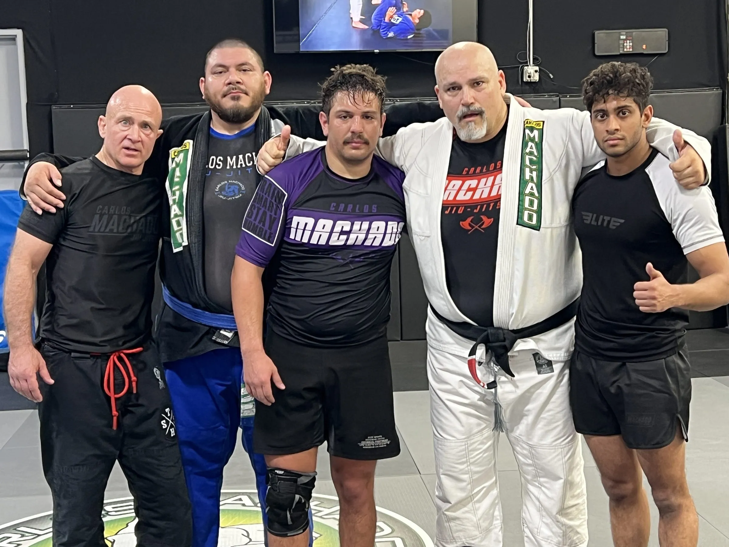 Adult members of Machado Method Carrollton standing together in no-gi training gear after a session