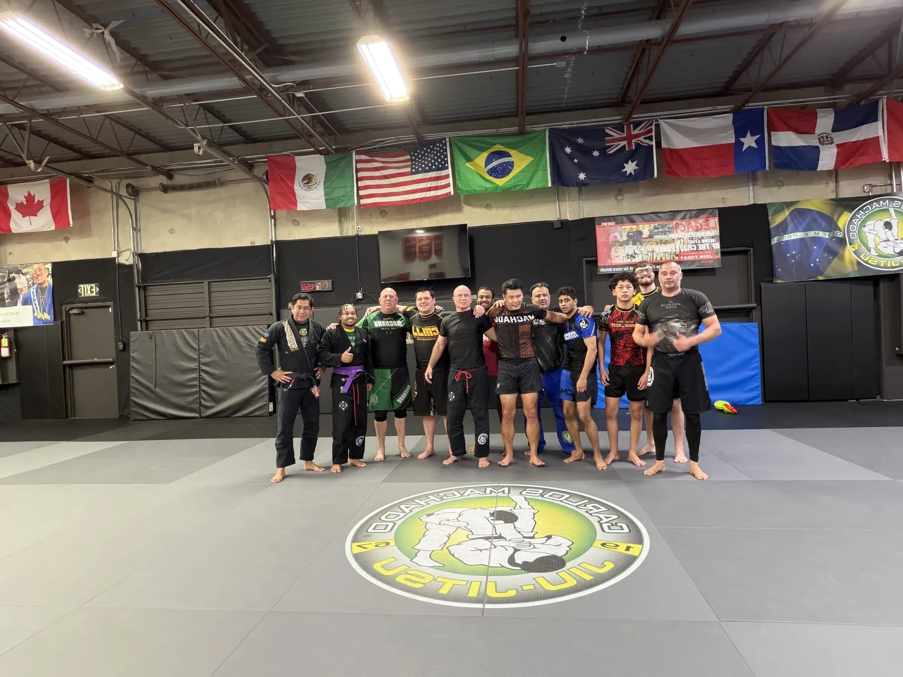 Two adult Machado Method students rolling during a Brazilian Jiu-Jitsu class in Carrollton, TX
