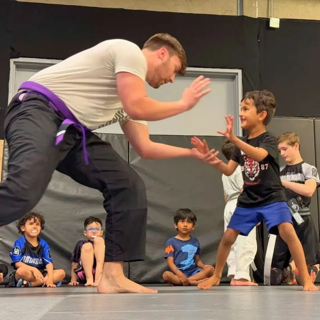 A Machado Method coach leading a kids jiu-jitsu class after school in Carrollton, TX