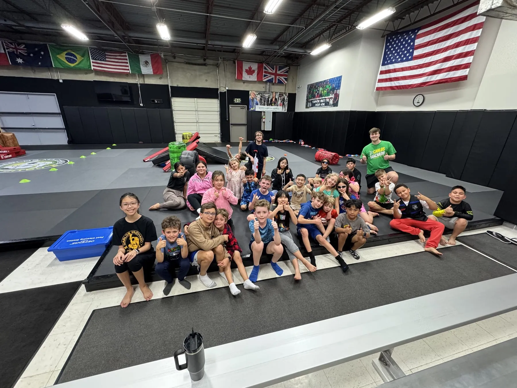 Machado Method kids sitting together across the mat after class in Carrollton, TX