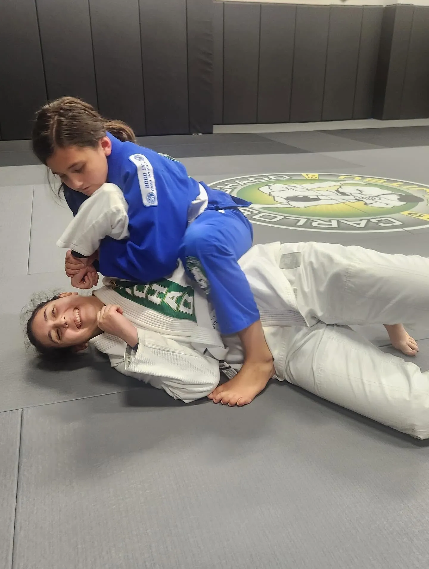 A young Machado Method student controlling a partner during jiu-jitsu training in Carrollton, TX