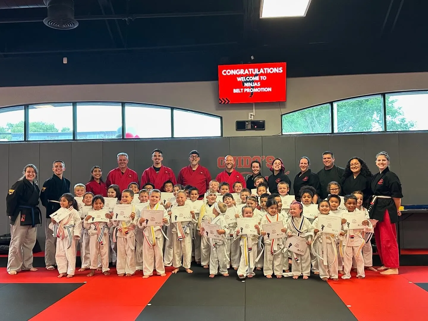 Machado Method students celebrating at a belt promotion in Carrollton, TX