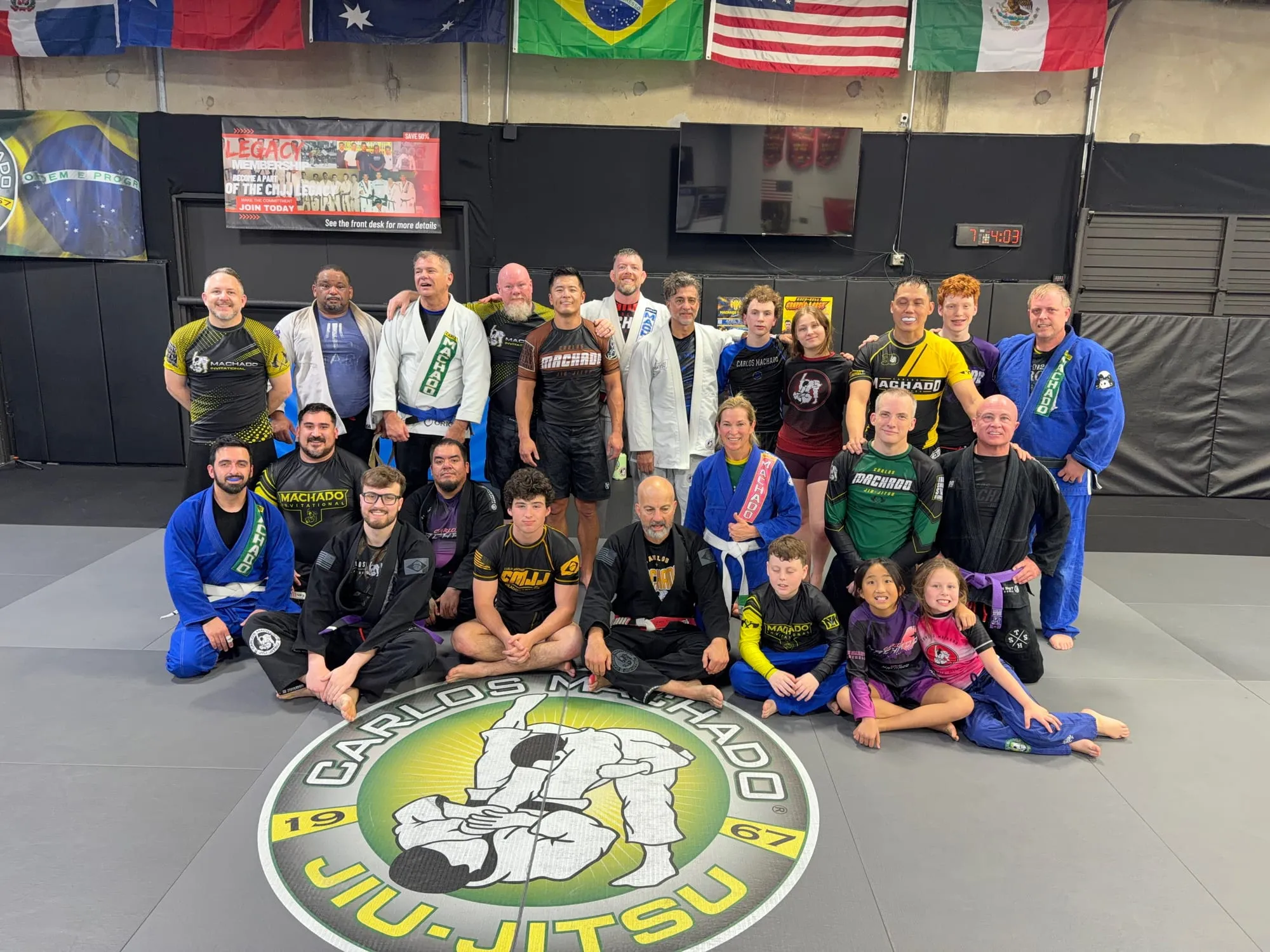 Machado Method students of all ages together on the mat after class in Carrollton, TX