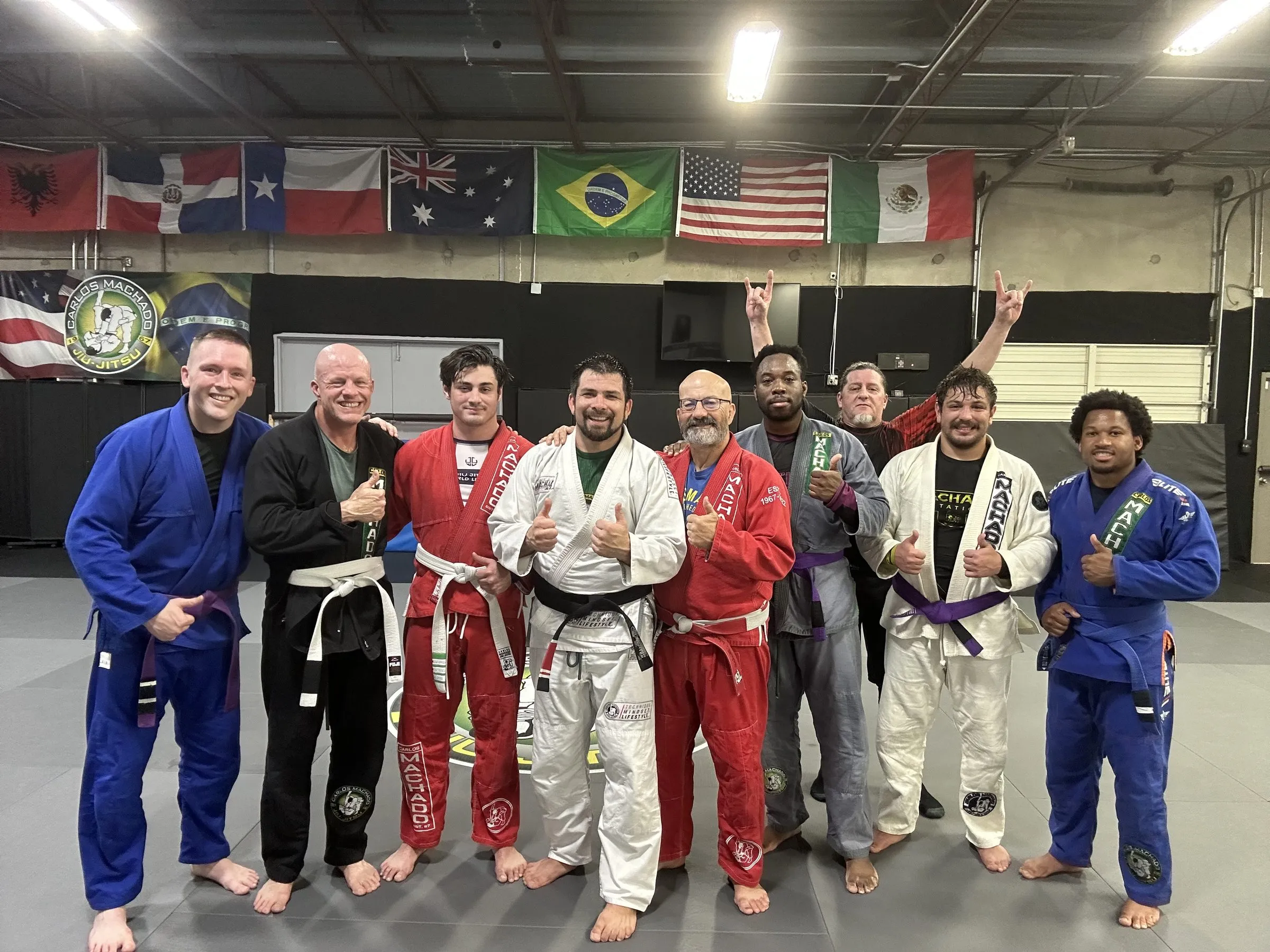 Machado Method students celebrating together in their gis after a promotion at the Carrollton academy