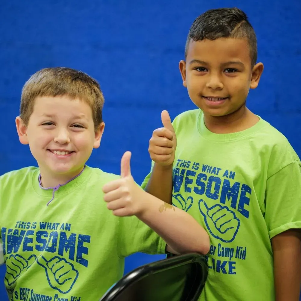 Two Machado Method summer campers giving a thumbs up in Carrollton, TX